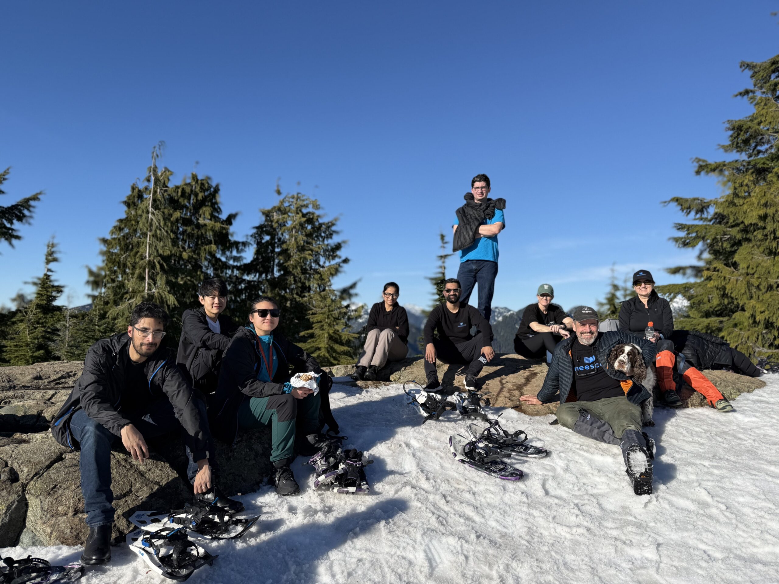 Meescan co-workers sit on the summit of snowy Dog Mountain